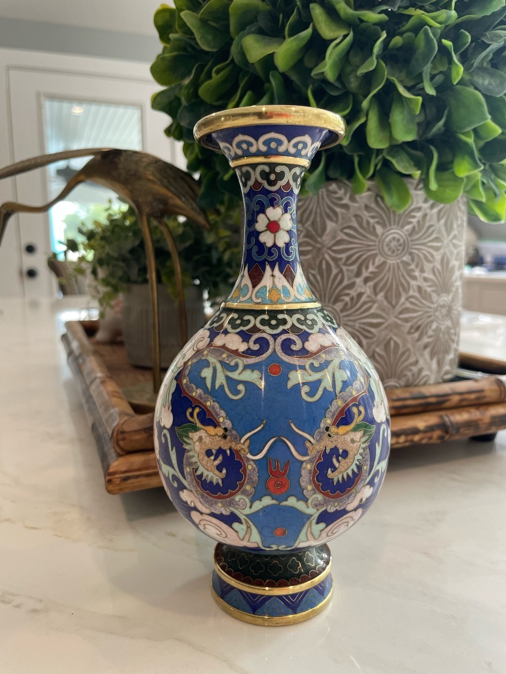 Vintage Chinese cloisonné footed vase featuring dragons and clouds.